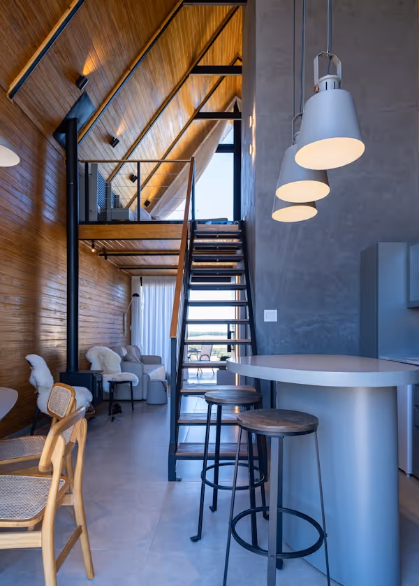 Modern interior with wooden walls and industrial staircase.